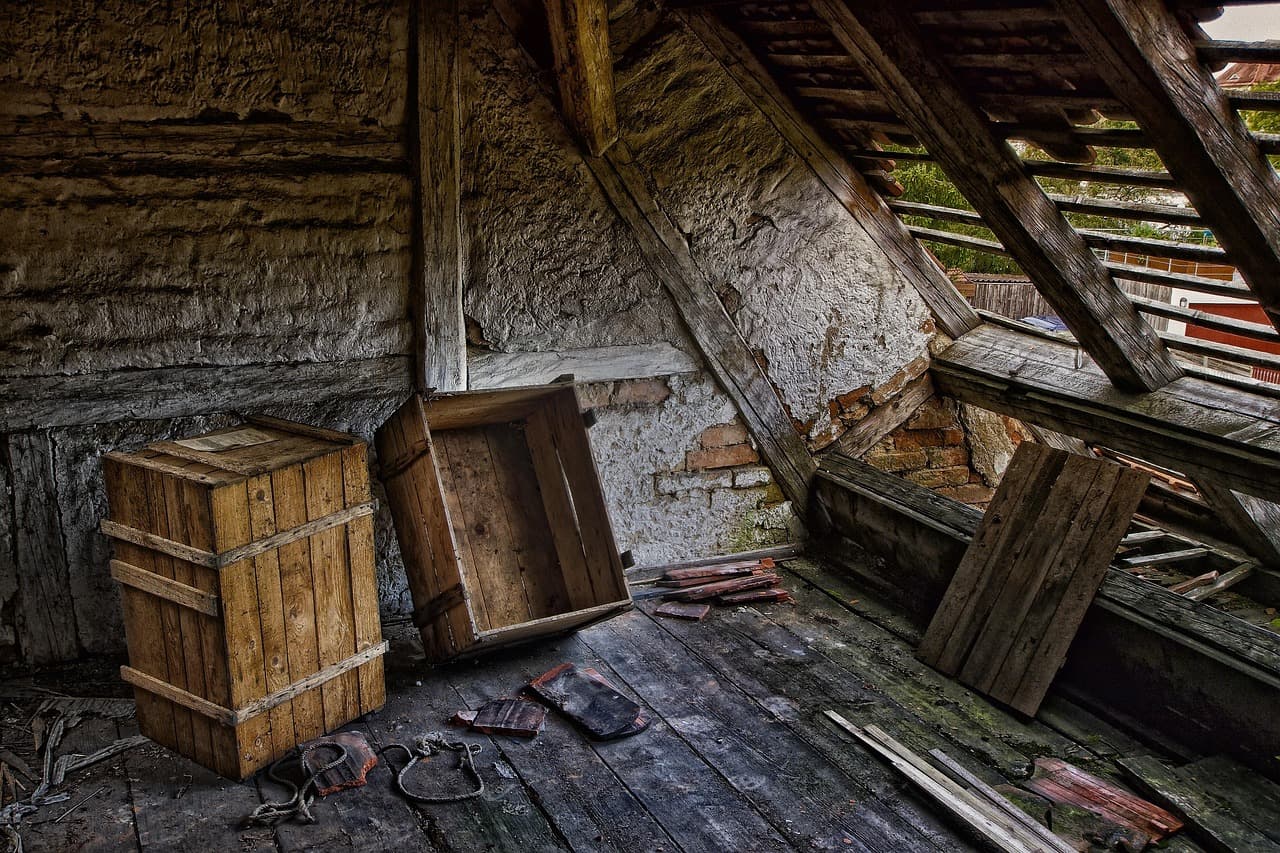 Timber rafters in a dark, dusty loft