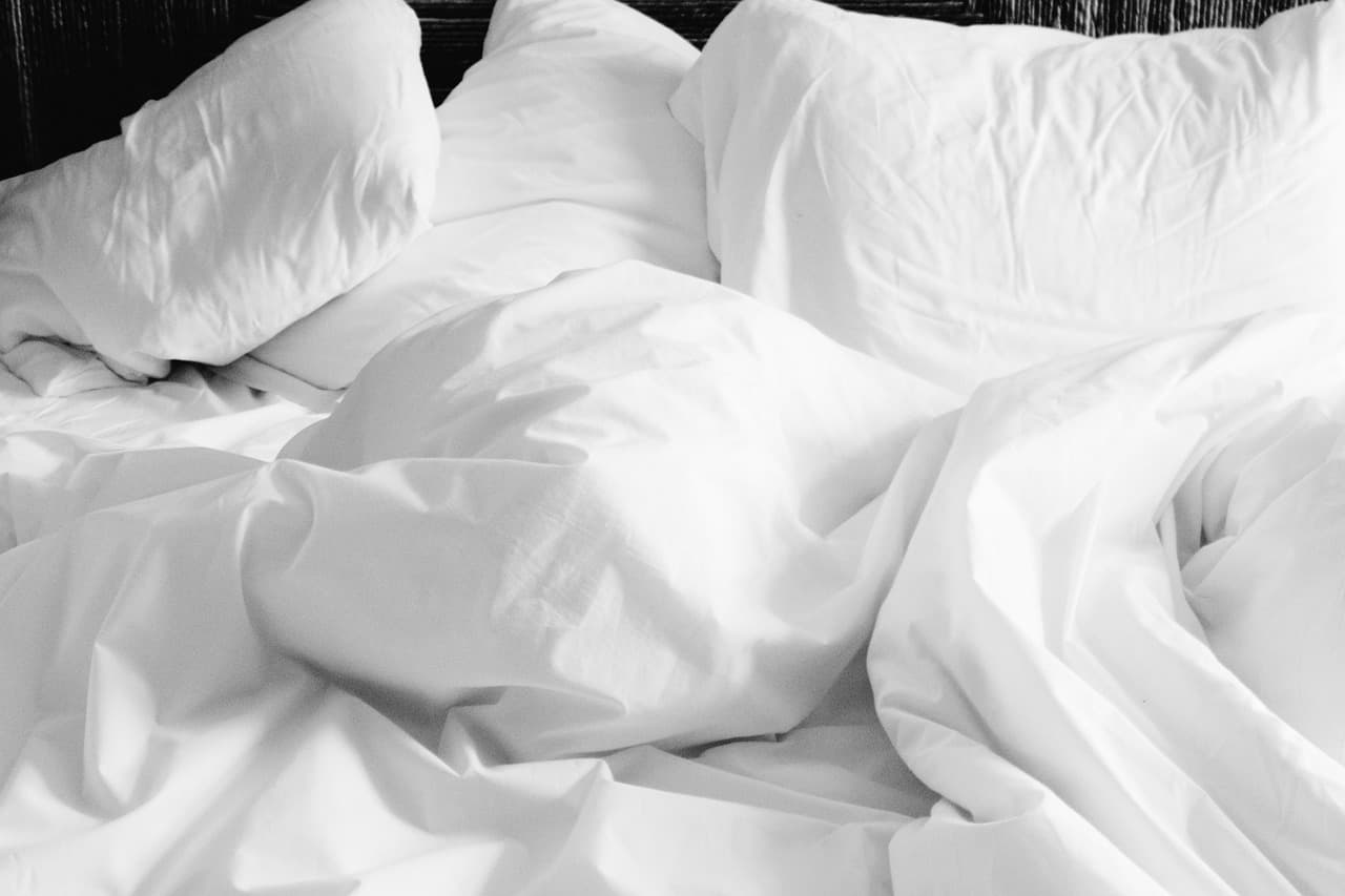 Crumpled white bed linen